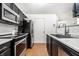 Updated kitchen featuring stainless steel appliances, stylish backsplash, and modern cabinetry at 1242 Freemont Ln, Greenwood, IN 46143