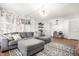 Comfortable living room featuring a brick accent wall, a large sofa, and stylish decor at 1242 Freemont Ln, Greenwood, IN 46143