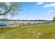 Scenic backyard view showcasing a lush green lawn leading to a tranquil lake with boat docks at 129 Rosewood Dr, Cicero, IN 46034