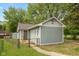 Exterior side view of the home with a fenced yard, small garden area, and well-kept lawn at 129 Rosewood Dr, Cicero, IN 46034