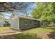 Charming home exterior featuring a well-maintained yard, gray siding, and shuttered windows at 129 Rosewood Dr, Cicero, IN 46034