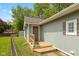 Charming home featuring a wooden porch, blue flower pot, and visible house number at 129 Rosewood Dr, Cicero, IN 46034