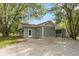 Back of home shows gravel driveway and green grass, as well as a storage shed at 129 Rosewood Dr, Cicero, IN 46034