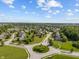 Expansive community aerial view shows mature trees, sidewalks, and Gathering homes at 13553 Lorenzo Blvd, Carmel, IN 46074