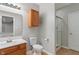 Bathroom includes a vanity with wood cabinets, framed mirror, toilet, and glass shower at 13553 Lorenzo Blvd, Carmel, IN 46074