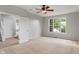 Bedroom with ceiling fan, large window, and access to living spaces at 13553 Lorenzo Blvd, Carmel, IN 46074