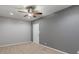 Neutral bedroom with plush carpet, gray accent wall, and a ceiling fan with light at 13553 Lorenzo Blvd, Carmel, IN 46074
