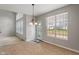 Bright dining area features tile floors, a chandelier, and a large window overlooking the backyard at 13553 Lorenzo Blvd, Carmel, IN 46074