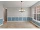 Bright dining room with wainscoting detail, chandelier, and large window view at 13553 Lorenzo Blvd, Carmel, IN 46074