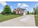Wide concrete driveway leading to a two-car garage, surrounded by well-kept lawn at 13553 Lorenzo Blvd, Carmel, IN 46074