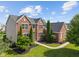 Charming two-story brick home with manicured landscaping and a welcoming entrance at 13553 Lorenzo Blvd, Carmel, IN 46074