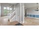 Welcoming foyer with staircase, tile flooring, and view into living spaces at 13553 Lorenzo Blvd, Carmel, IN 46074