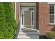 Inviting front entrance with sidelights, showcasing brick facade and landscaped greenery at 13553 Lorenzo Blvd, Carmel, IN 46074