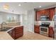 Kitchen with stainless steel appliances and views to backyard and dining area at 13553 Lorenzo Blvd, Carmel, IN 46074