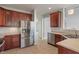 Kitchen with stainless steel refrigerator and dishwasher, beautiful cabinets and tile floor at 13553 Lorenzo Blvd, Carmel, IN 46074