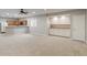 Spacious living room features a wet bar, neutral paint, modern lighting, and plush carpeting at 13553 Lorenzo Blvd, Carmel, IN 46074