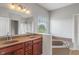 Bathroom with double sinks, large tub, and bright natural light at 13553 Lorenzo Blvd, Carmel, IN 46074