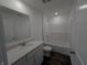 Bright bathroom featuring a vanity with stone counter, a toilet, and a tub with white tile surround at 1400 Bluebonnet Pl, Shelbyville, IN 46176