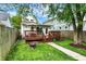 A spacious backyard with a wooden deck, a fire pit, and a well-maintained lawn at 1434 Laurel St, Indianapolis, IN 46203