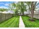 The backyard has a long walkway, a fenced yard, and a view of the home at 1434 Laurel St, Indianapolis, IN 46203
