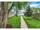 The backyard offers a peaceful retreat with its well-kept lawn, walkway, and privacy fence at 1434 Laurel St, Indianapolis, IN 46203