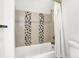 Bathroom with stylish tile accent, modern tub, and shower curtain at 1434 Laurel St, Indianapolis, IN 46203