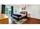 Bright bedroom with deck access, hardwood floors, and a modern upholstered bed frame at 1434 Laurel St, Indianapolis, IN 46203