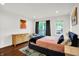 Cozy bedroom featuring hardwood floors, modern art, and abundant natural light at 1434 Laurel St, Indianapolis, IN 46203
