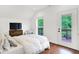 Bright bedroom with deck access, hardwood floors, and a cozy sitting area at 1434 Laurel St, Indianapolis, IN 46203