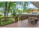 Wooden deck featuring chairs, table and staircase to a fenced yard at 1434 Laurel St, Indianapolis, IN 46203