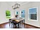 Bright dining room with large windows, modern lighting, and hardwood floors creating an inviting space at 1434 Laurel St, Indianapolis, IN 46203