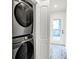 Modern laundry area with stacked washer and dryer, stylish flooring, and easy access to the backyard at 1434 Laurel St, Indianapolis, IN 46203