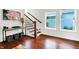 Bright living room featuring hardwood floors, staircase, and decorative shelving unit at 1434 Laurel St, Indianapolis, IN 46203