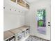 Functional mudroom with built-in bench, storage baskets, hooks, and access to the backyard at 1434 Laurel St, Indianapolis, IN 46203