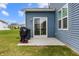 Cozy back patio with a grill, perfect for outdoor cooking and relaxation, complementing the home's blue siding at 1464 Buckland Ct, Avon, IN 46123