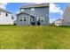 Expansive backyard with lush green grass, a blue home exterior, and a patio area with a grill at 1464 Buckland Ct, Avon, IN 46123