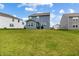 Large backyard with green lawn, showcasing the home's blue siding and neighboring houses at 1464 Buckland Ct, Avon, IN 46123
