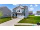 Beautiful two-story home features a two-car garage, blue and gray siding, and a well-manicured lawn at 1464 Buckland Ct, Avon, IN 46123