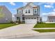 Charming two-story home features a two-car garage, blue and gray siding, and a well-manicured lawn at 1464 Buckland Ct, Avon, IN 46123