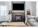 Elegant fireplace with wooden mantle and modern design, complemented by stylish decor and soft lighting at 1464 Buckland Ct, Avon, IN 46123