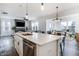 Bright, open-concept kitchen with stainless steel appliances and large center island flowing into the living area at 1464 Buckland Ct, Avon, IN 46123
