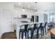 Stylish kitchen featuring white cabinets, a subway tile backsplash, and a spacious island with barstool seating at 1464 Buckland Ct, Avon, IN 46123