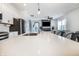 Open kitchen featuring a large island with quartz countertops and stainless steel sink overlooking the living area at 1464 Buckland Ct, Avon, IN 46123
