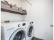 Well-organized laundry room featuring modern white appliances and stylish shelving for storage at 1464 Buckland Ct, Avon, IN 46123