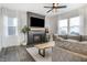 Stylish living room featuring a modern fireplace, large sectional sofa, and an elegant ceiling fan at 1464 Buckland Ct, Avon, IN 46123