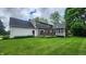 Well-maintained backyard features a deck, screened-in porch, lush lawn, and mature trees at 1536 Copperwood Pl, Carmel, IN 46033