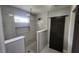 Contemporary shower with marble and gray tones, sleek fixtures, and a built-in shelf for storage and decor at 1536 Copperwood Pl, Carmel, IN 46033