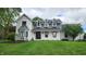 Stunning two-story home featuring a brick exterior, well-manicured lawn, and elegant architectural details at 1536 Copperwood Pl, Carmel, IN 46033