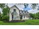Charming two-story home boasting a beautiful brick facade, bay window, and lush green landscaping at 1536 Copperwood Pl, Carmel, IN 46033