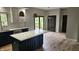 Well-designed kitchen with an island and a breakfast area with sliding glass door access to the outside deck at 1536 Copperwood Pl, Carmel, IN 46033